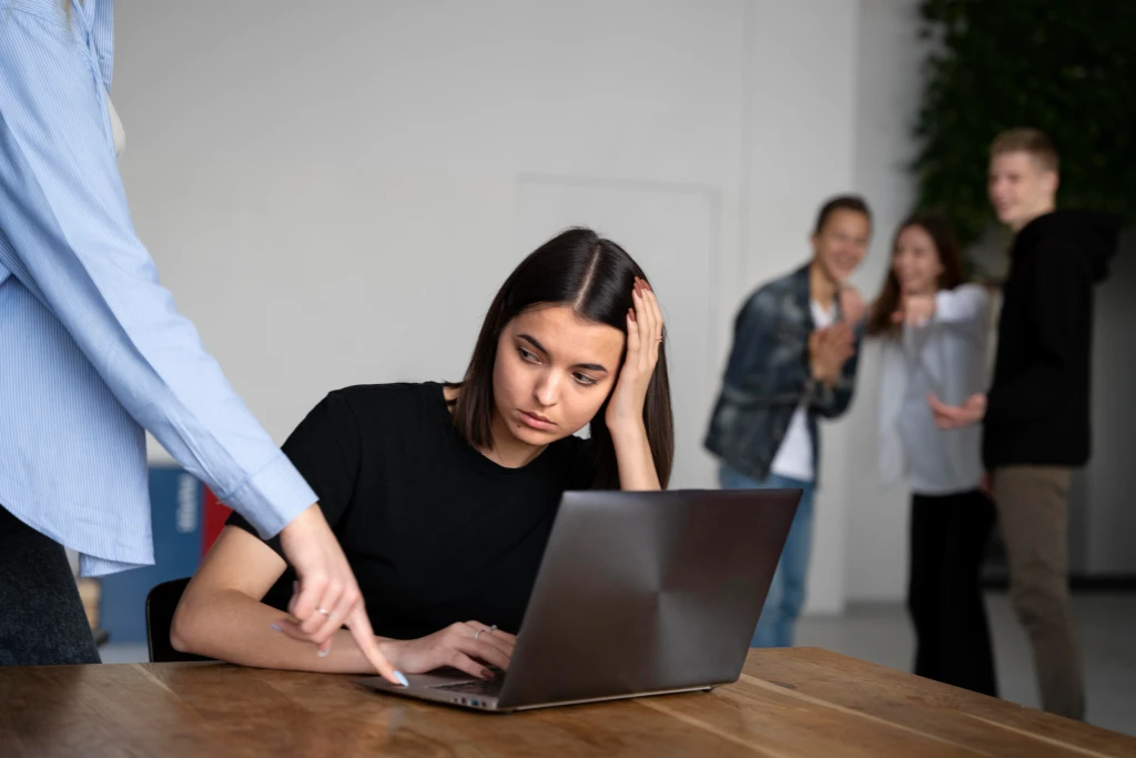 A stressed female employee in a toxic workplace culture.