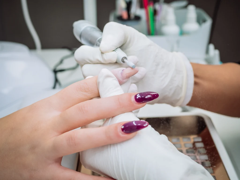 nail technician polishing nails