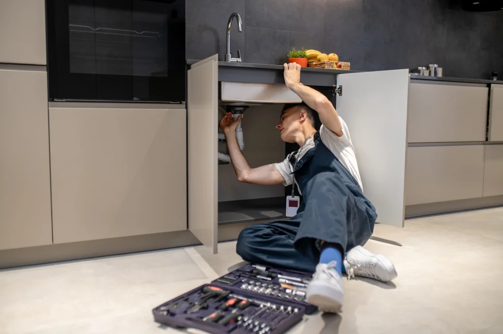 plumber working on a sink