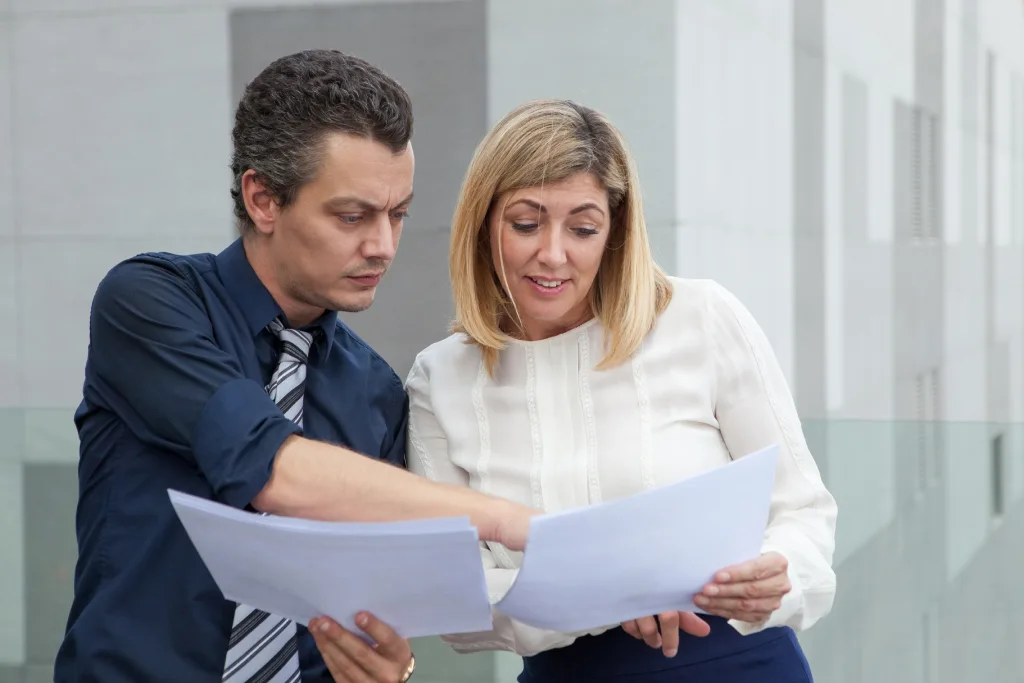 two colleagues reviewing safeguarding policy documents together