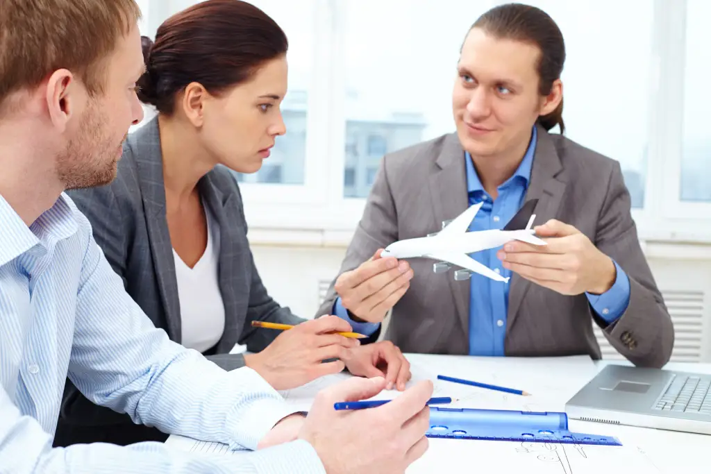 Three colleagues discussing a career in aviation management